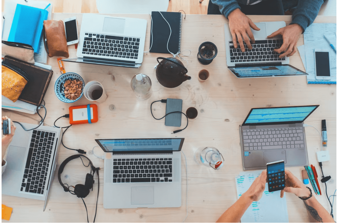 A shared workspace with laptops and digital tools